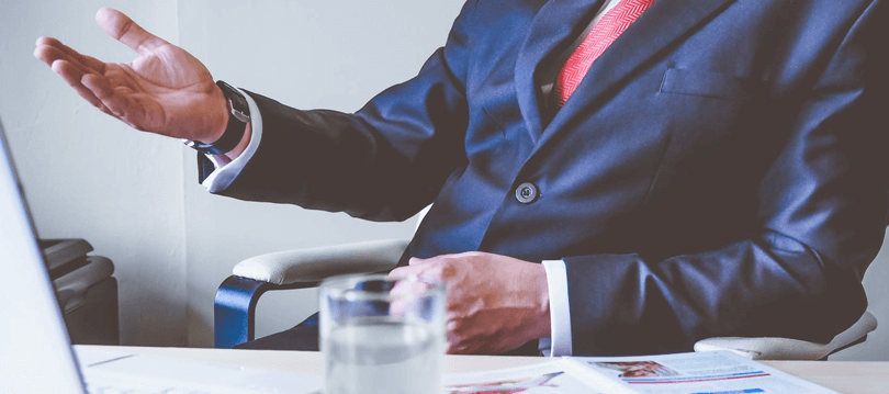 A man with suit working on laptop